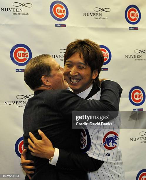 Chicago Cubs new pitcher Kyuji Fujikawa tgets a hug from his agent Arn Tellem hat December 7, 2012 at Wrigley Field in Chicago, Illinois.