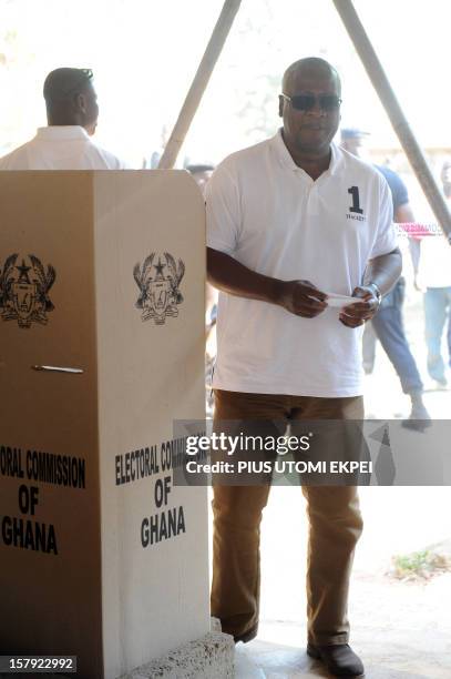 Ghana's ruling National Democratic Congress president and presidential candidate John Dramani Mahama steps out of the polling booth to cast his vote...