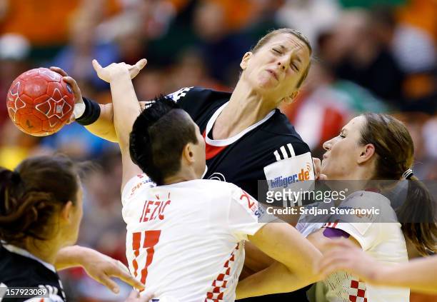 Anne Loerper of Germany is challenged by Katarina Jezic of Croatia during the Women's European Handball Championship 2012 Group C match between...
