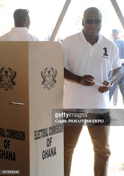 Ghana's ruling National Democratic Congress president and presidential candidate John Dramani Mahama steps out of the polling booth to cast his vote...