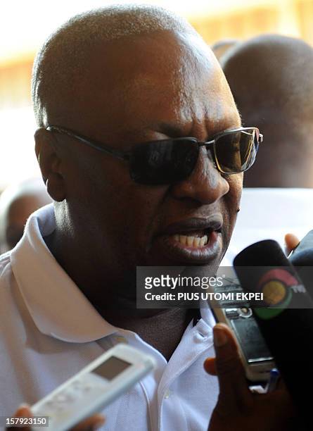 Ghana's ruling National Democratic Congress president and presidential candidate John Dramani Mahama talks to the press after casting his vote at the...