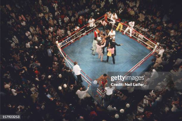World Heavyweight Title: Aerial view of Muhammad Ali victorious with cornermen as fans begin to rush the ring after round 8 knockout of George...