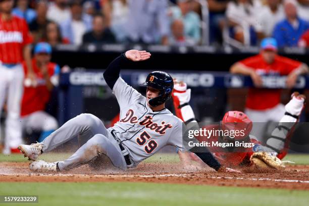 Jacob Stallings of the Miami Marlins tags out Zack Short of the Detroit Tigers at home plate during the seventh inning of the game at loanDepot park...