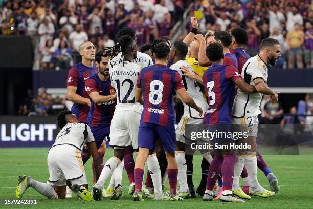 Players scuffle after Frenkie de Jong of FC Barcelona is shown a yellow card during the first half of the pre-season friendly match against Real...