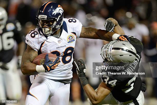 Demaryius Thomas of the Denver Broncos breaks the tackle of Mike Mitchell of the Oakland Raiders in the first quarter at Oakland-Alameda County...