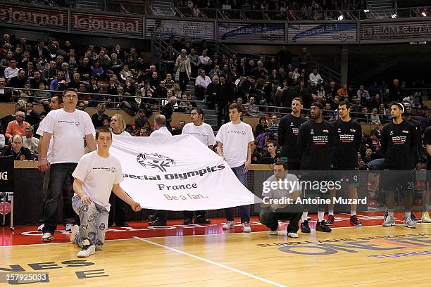 Special Olympics athletes stand with Besiktas JK Istanbul players and FC Barcelona Regal players during a Special Olympics ceremony before the...