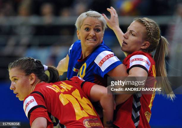 Romania's Ionela Stanca vies with Montenegro's Suzana Lazovic and Andrea Klikovac during their Women's EHF Euro 2012 Handball Championship match...