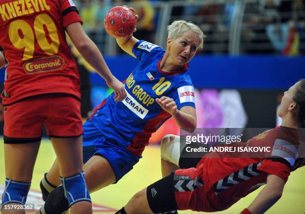 Romania's Ionela Stanca vies with Montenegro's Suzana Lazovic during their Women's EHF Euro 2012 Handball Championship match Romania vs Montenegro on...