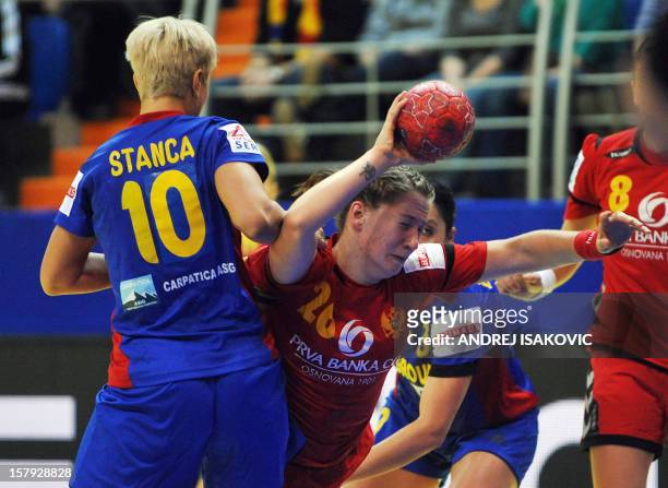 Montenegro's Suzana Lazovic vies with Romania's Ionela Stanca during the Women's EHF Euro 2012 Handball Championship match Romania vs Montenegro on...