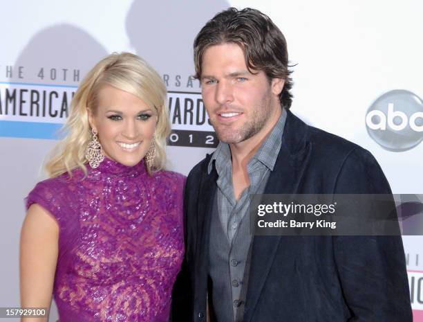 Singer Carrie Underwood and her husband hockey player Mike Fisher arrive at The 40th American Music Awards at Nokia Theatre L.A. Live on November 18,...