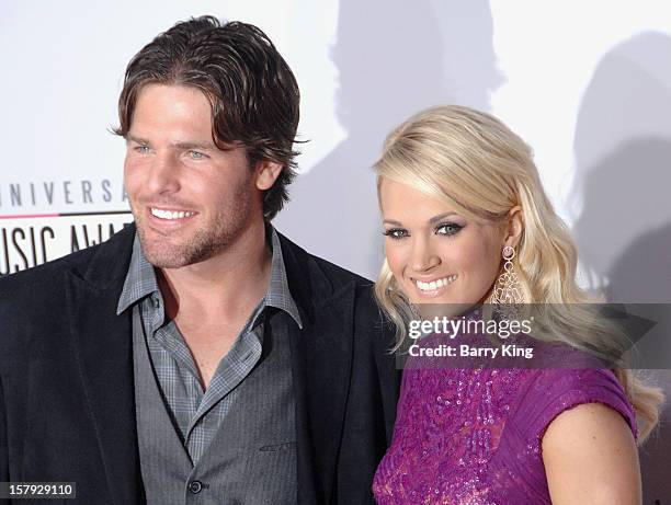 Singer Carrie Underwood and her husband hockey player Mike Fisher arrive at The 40th American Music Awards at Nokia Theatre L.A. Live on November 18,...