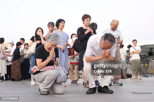People visit and say prayers at the cenotaph for the atomic bomb victims at the Peace Memorial Park in Hiroshima on August 6 to mark the 78th...