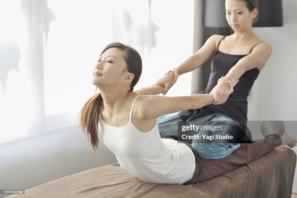 Young woman receiving Thai massage