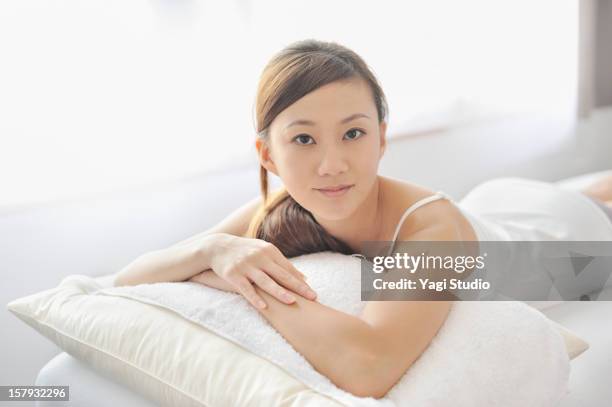 woman relaxing on the bed - camisole stock pictures, royalty-free photos & images