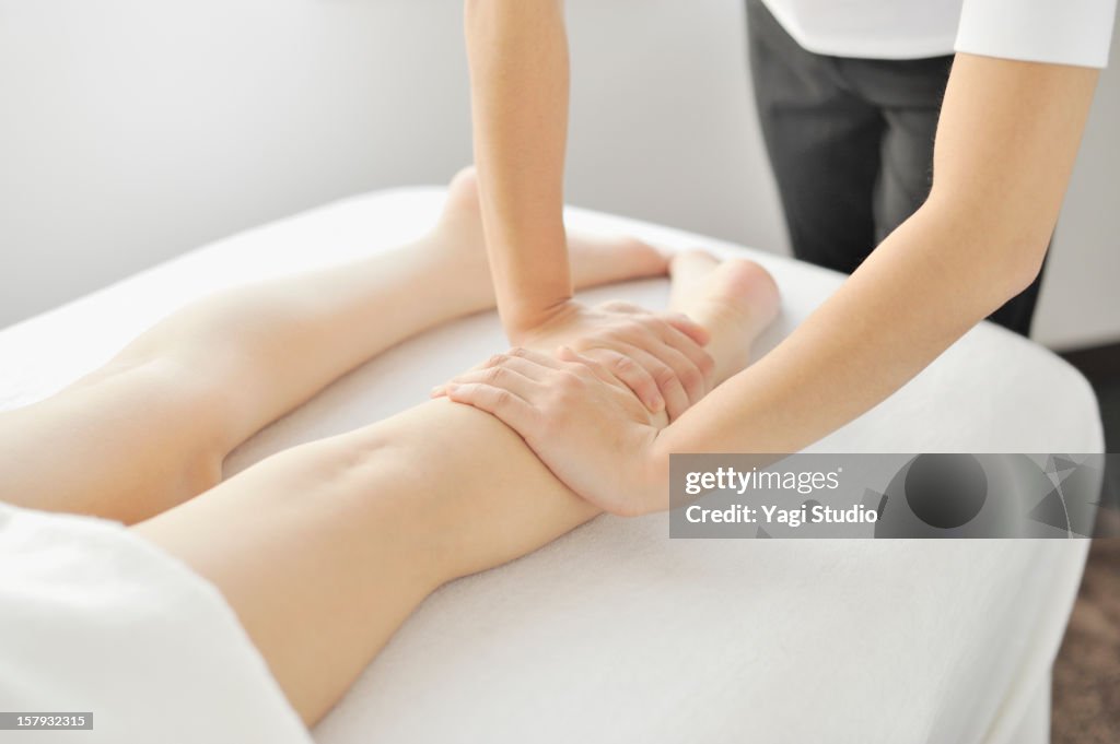 Young woman receiving foot massage