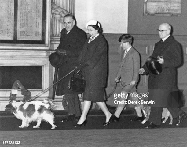 Queen Elizabeth II and Prince Charles walk through Liverpool Street Station in London with their dogs, having returned by train from Sandringham...