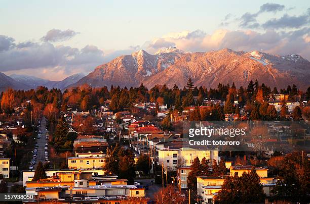 vancouver mountains with snow at sunset - vancouver stock pictures, royalty-free photos & images