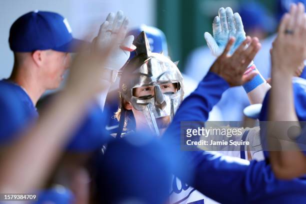 Bobby Witt Jr. #7 of the Kansas City Royals is congratulated by teammates in the dugout after hitting a solo home run during the 1st inning of the...