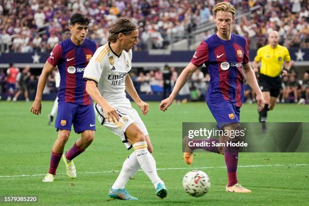 Luka Modrić of Real Madrid passes the ball during the second half of the pre-season friendly match against FC Barcelona at AT&T Stadium on July 29,...