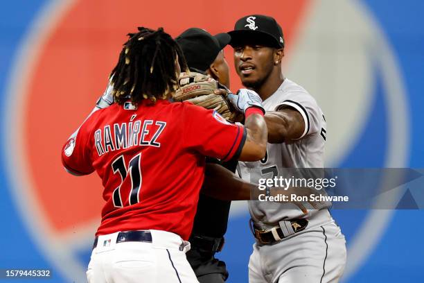 Jose Ramirez of the Cleveland Guardians and Tim Anderson of the Chicago White Sox start to fight as umpire Malachi Moore gets between them during the...