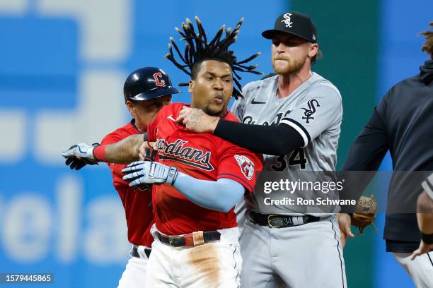 Jose Ramirez of the Cleveland Guardians is held by Michael Kopech of the Chicago White Sox during a fight in the sixth inning at Progressive Field on...