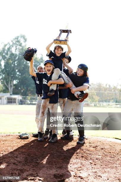 little league team celebrating with trophy. - child trophy stock-fotos und bilder