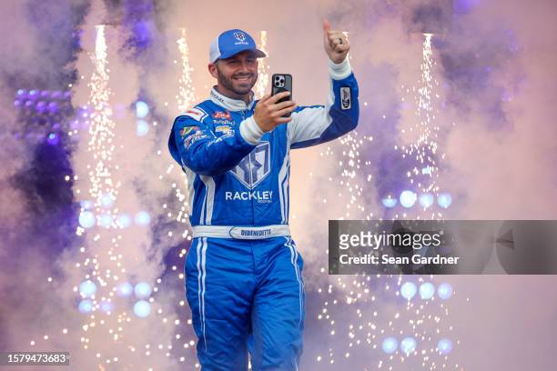 Matt DiBenedetto, driver of the Rackley Roofing Chevrolet, takes a selfie as he walks onstage during driver intros prior to the NASCAR Craftsman...