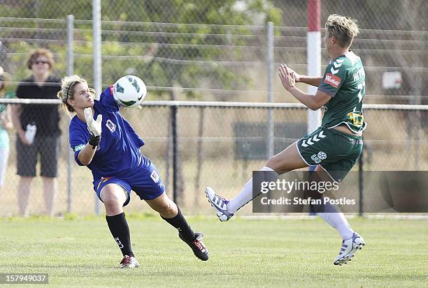 Newcastle Jets goal keeper Eliza Campbell stops a shot on goal by Michelle Heyman of Canberra United during the round eight W-League match between...