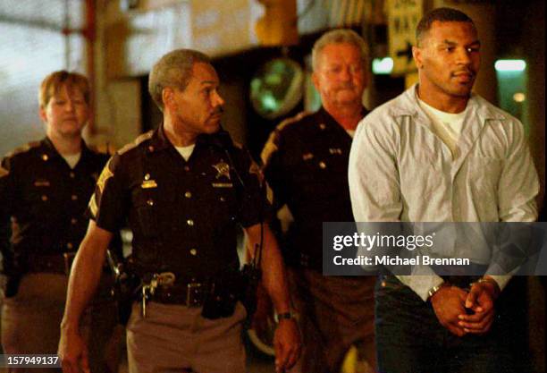 Former heavyweight world champion boxer Mike Tyson is led away in handcuffs from the appellate court in Indianapolis after his appeal against a rape...