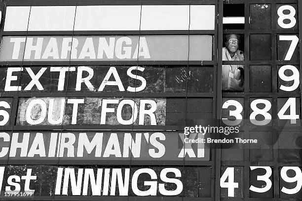 Scoreboard operator watches play during an international tour match between the Chairman's XI and Sri Lanka from inside The Jack Fingleton Scoreboard...