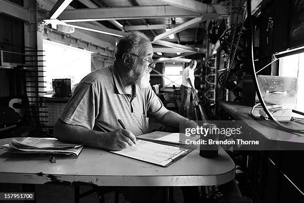 Scoreboard operator watches play during an international tour match between the Chairman's XI and Sri Lanka from inside The Jack Fingleton Scoreboard...