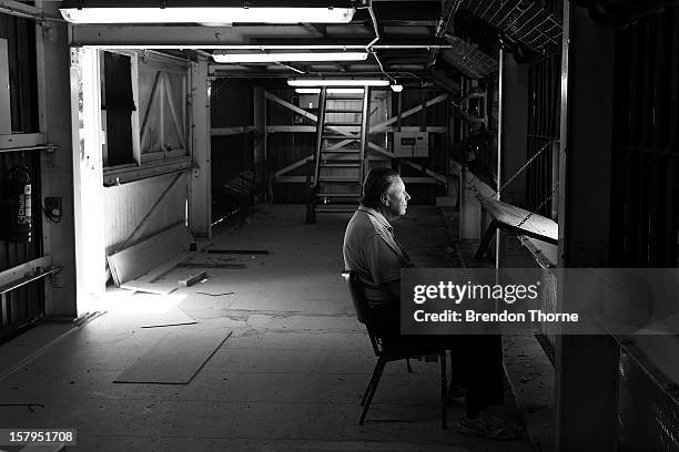 Scoreboard operator watches play during an international tour match between the Chairman's XI and Sri Lanka from inside The Jack Fingleton Scoreboard...