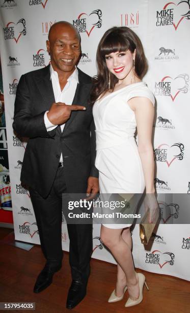 Former professional boxer Mike Tyson and 2011 Playboy Plymate of the Year Claire Sinclair Claire Sinclair attend the Launch Party for "Mike Tyson...