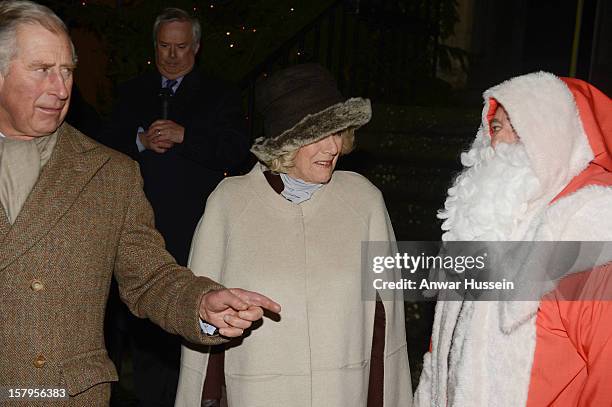 Prince Charles, Prince of Wales and Camilla, Duchess of Cornwall meet Father Christmas as they switch on the Christmas lights on December 7, 2012 in...