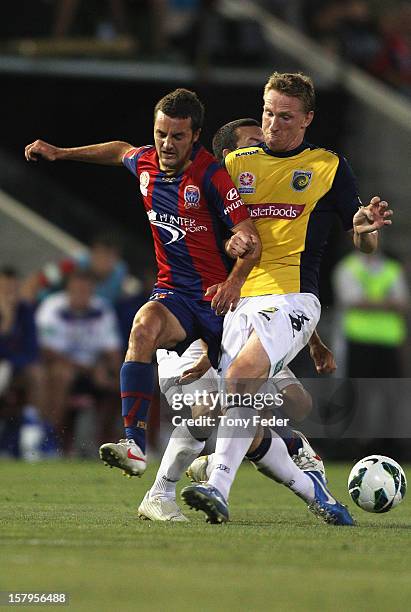 James Virgili of the Jets and Daniel McBreen of the Mariners contest the ball during the round ten A-League match between the Newcastle Jets and the...