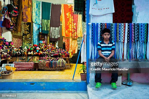 Boy tends his family store on Isla Mujeres. Isla Mujeres, Quintana Roo, Mexico.