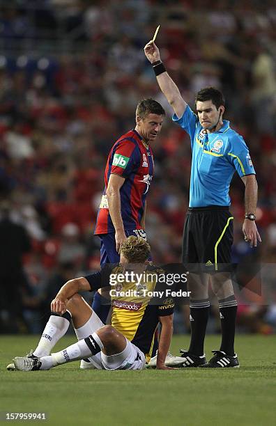 Michael Bridges of the Jets is shown a yellow card during the round ten A-League match between the Newcastle Jets and the Central Coast Mariners at...