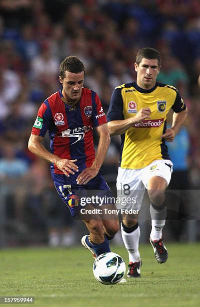James Virgilli of the Jets controls the ball in front of Nick Montgomery of the Mariners during the round ten A-League match between the Newcastle...