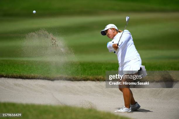Ai Suzuki of Japan hits from a bunker on the 7th hole during the final round of Rakuten Super Ladies at Tokyu Grand Oak Golf Club on July 30, 2023 in...