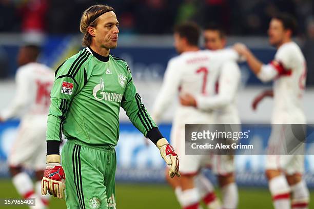 Goalkeeper Timo Hildebrand of Schalke reacts as Vedad Ibisevic of Stuttgart celebrates his team's second goal with team mates during the Bundesliga...