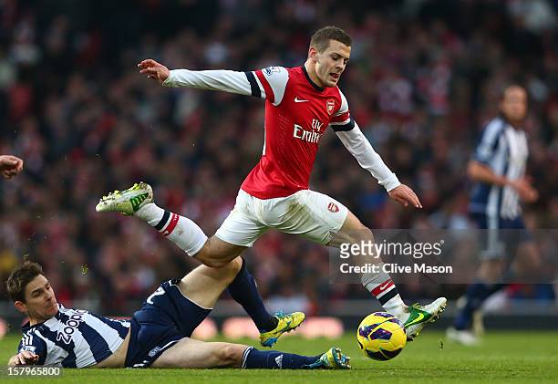 Jack Wilshere of Arsenal evades the tackle from Zoltan Gera of West Bromwich Albion during the Barclays Premier League match between Arsenal and West...