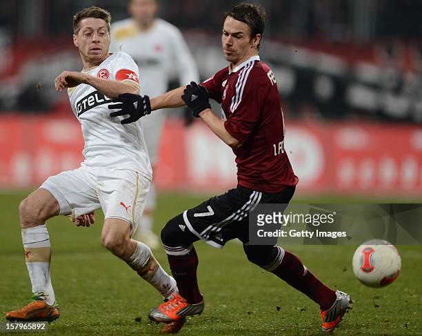 Andreas Lambertz of Duesseldorf is challenged by Markus Feulner of Nuremberg during the Bundesliga match between 1. FC Nuernberg and Fortuna...
