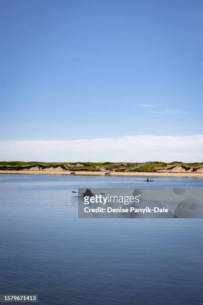 silhouette of rowboat on pond - panyik-dale stock pictures, royalty-free photos & images