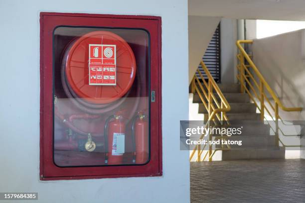 fire extinguisher cabinet in the hall of office building for preparing to prevent fire, fire extinguisher equipment for protection - apartment fire stock pictures, royalty-free photos & images