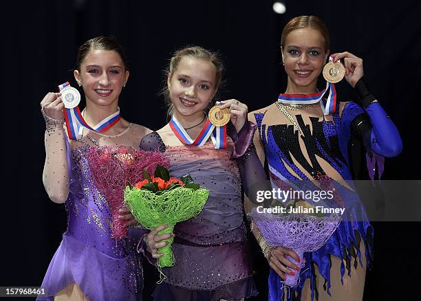 Hannah Miller of USA with her silver medal, Elena Radionova of Russia with her gold and Anna Pogorilaya of Russia with her bronze medal in the Junior...