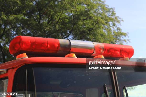 overhead siren and flashing red lights on a fire truck - vehicle light fotografías e imágenes de stock