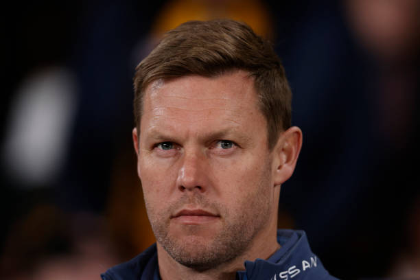 Sam Mitchell, coach of the Hawks walks down to the 1/4 time huddle during the round 20 AFL match between Hawthorn Hawks and St Kilda Saints at Marvel...