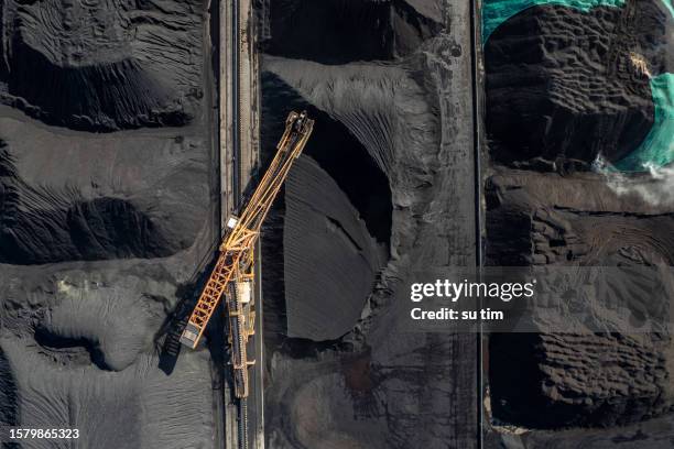 the factory land full of coal is mechanically operating and transported - truck tipped over stock pictures, royalty-free photos & images