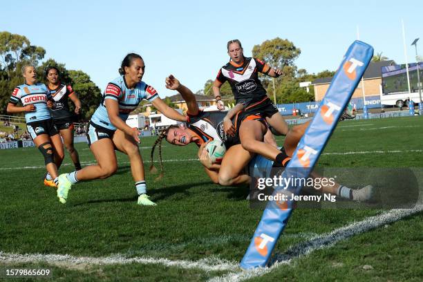 Jakiya Whitfield of the Tigers is tackled into touch during the round two NRLW match between Wests Tigers and Cronulla Sharks at Belmore Sports...