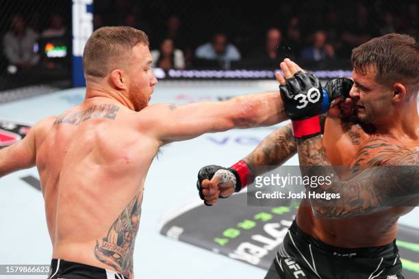 Justin Gaethje punches Dustin Poirier in a lightweight fight for the BMF belt during the UFC 291 event at Delta Center on July 29, 2023 in Salt Lake...